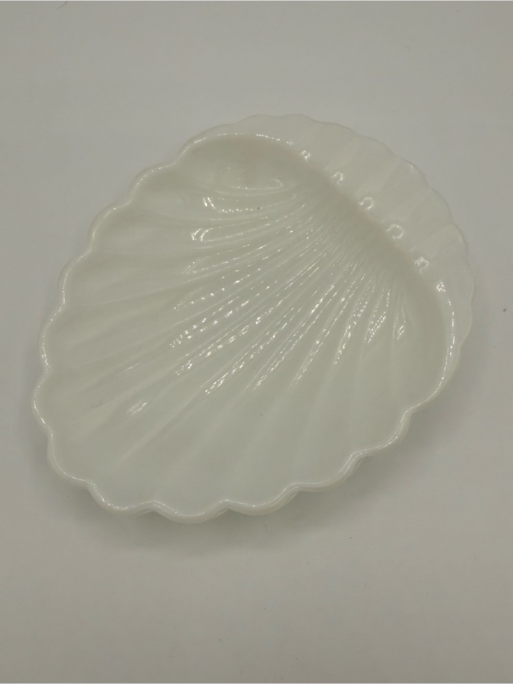 Vintage white milk glass shell-shaped trinket dish.